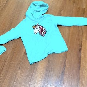 Baby blue sweater with sparkly unicorn in the center